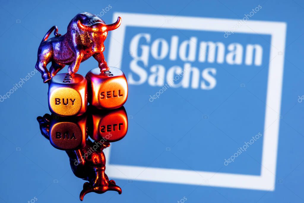 Kazan, Russia - Dec 20, 2021: Metal bull stands on buy-sell dices on background of Goldman Sachs bank logo