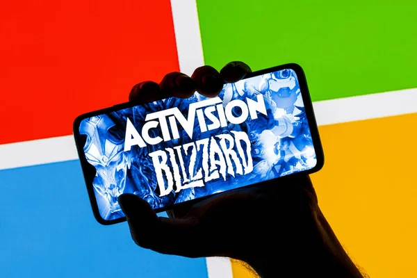 Kazan, Rusya - 18 Ocak 2022: Akıllı telefon ekranındaki Activision Blizzard logosu Microsoft logosu ile karşılaştırıldı. Microsoft video oyunu yayıncısı Activision Blizzard 'ın satın alındığını duyurdu.