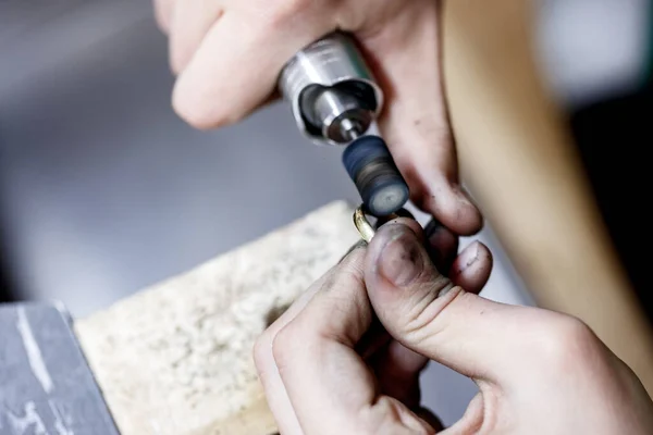 Closeup Hands Craftsman Jeweler Polishing Golden Ring Surface Grinding Machine Royalty Free Stock Images