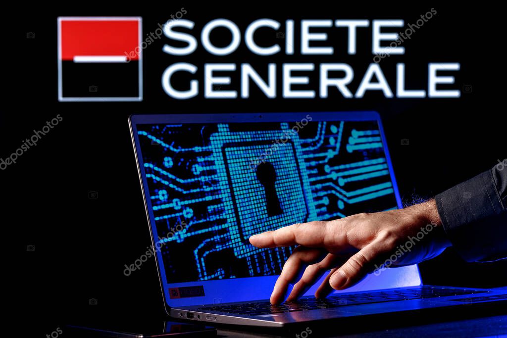 Kazan, Russia - Feb 21, 2022: Laptop with lock symbol on screen on background of  Societe Generale bank logo. Finger points to lock symbol. Concept of data hacking.