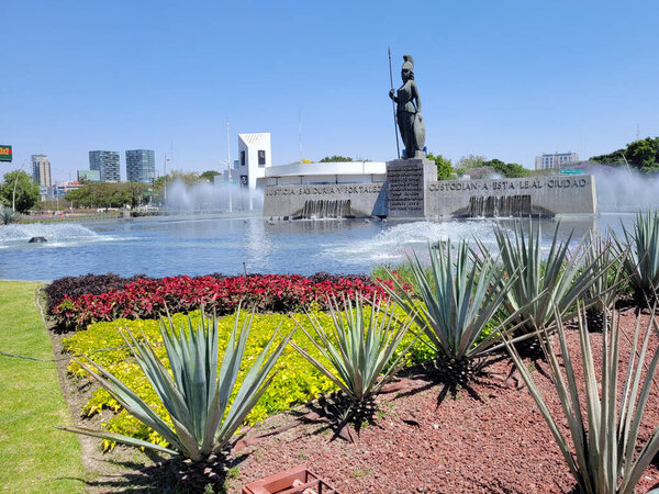 Street view of the minerva statue in Guadalajara with the fountain and agaves