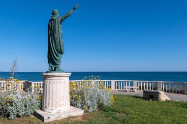 Anzio, İtalya, Nerone 'nin heykeli heykeltraş Claudio Valenti tarafından 2010 yılında deniz kenarında, mavi gökyüzü ve Tyrhenian denizi ile çevrili bir sütunun üzerinde açıldı.