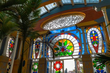 Inside the Moorish greenhouse the polychrome glass of the facade creates wonderful reflections and plays of light. The building is part of the Villa Torlonia Park in Rome, Italy.