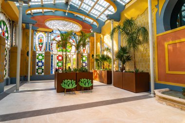 The polychrome glass of the Moorish greenhouse creates wonderful reflections and plays of light on the walls. Inside there are exotic and rare plants. Villa Torlonia park in Rome, Italy.