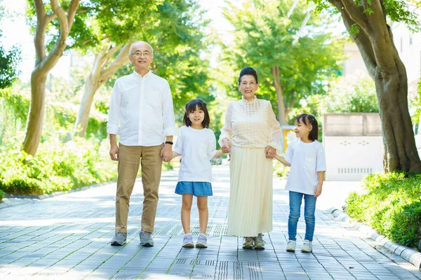 Senior Couple Taking Walk Grandchildren Greenly Street — Stock Photo, Image