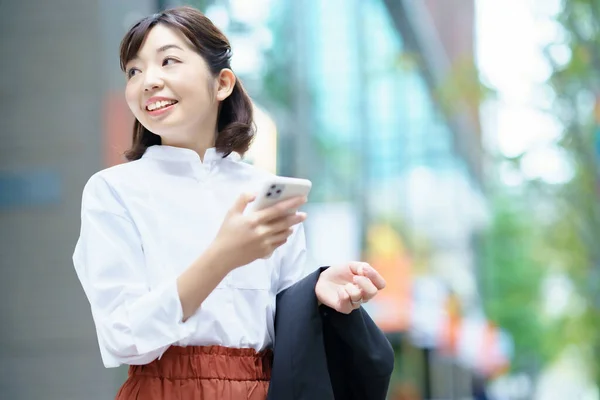 Asyalı Kadın Bir Akıllı Telefon Tutarak — Stok fotoğraf