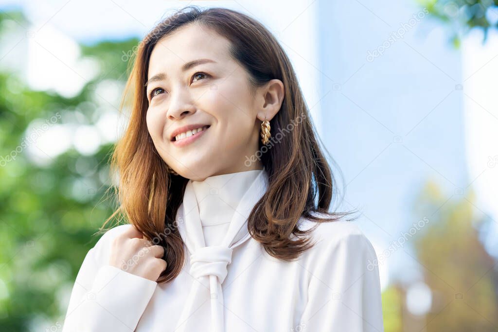 Outdoor portrait of smiling woman on fine day