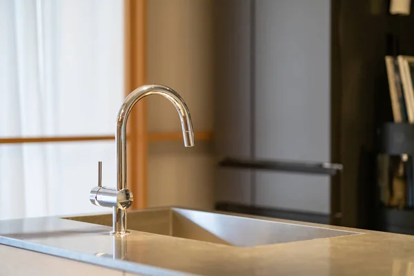 Water faucet installed in the crimson of the kitchen in the room