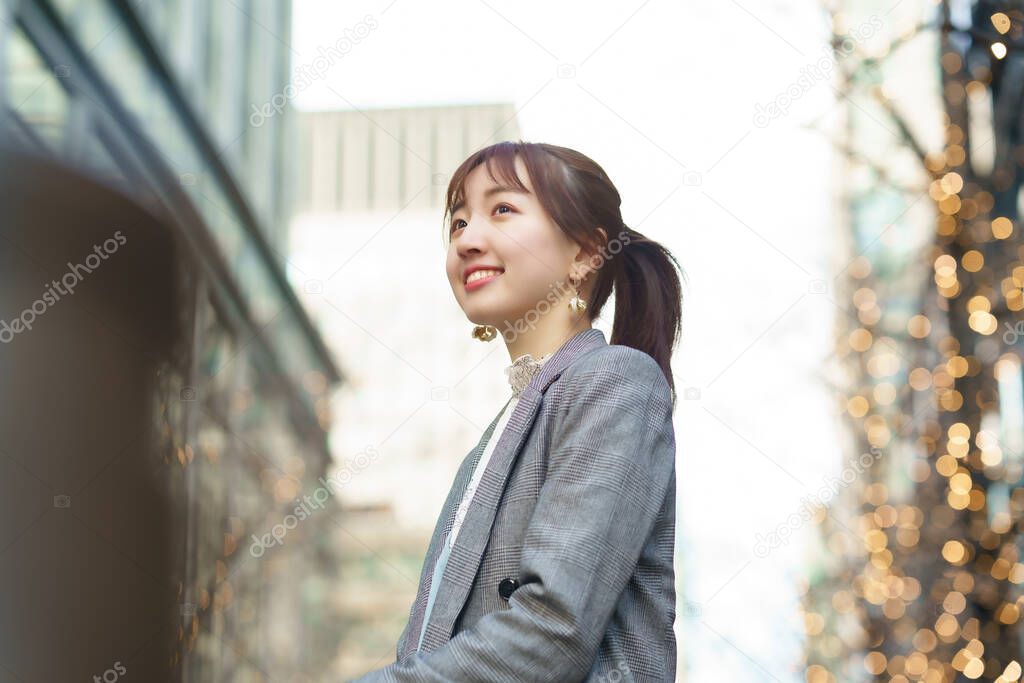 Asian young woman in a checkered jacket