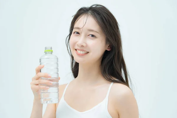 Mujer Bebiendo Agua Una Botella Plástico Interior —  Fotos de Stock