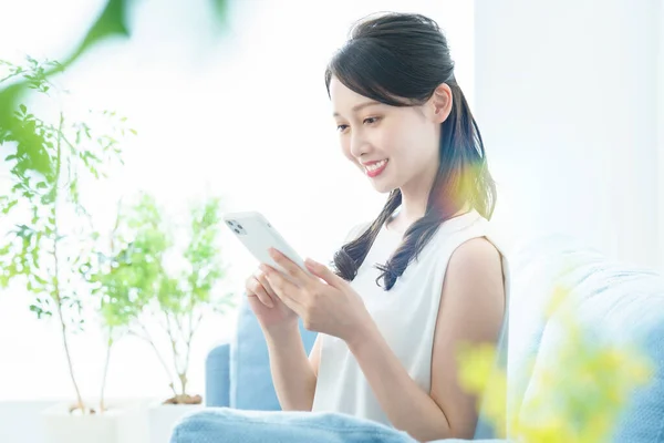 Woman Operating Smartphone Bright Room — ストック写真