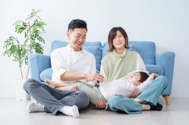 Aile, parlak bir odada kanepede dinleniyor.