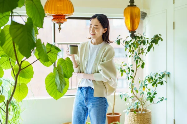 Asian Woman Relaxing Surrounded Foliage Plants —  Fotos de Stock