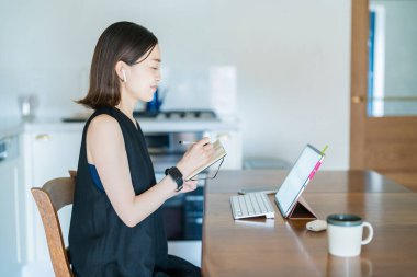 İnternet üzerinden tablet bilgisayar kullanan bir kadın.