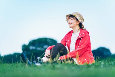 A young woman with a relaxed look on the meadow