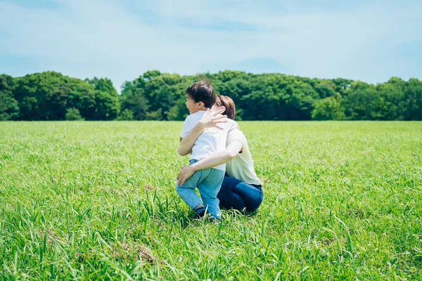 Mother Hugging Her Boy Green Space Fine Day — 图库照片