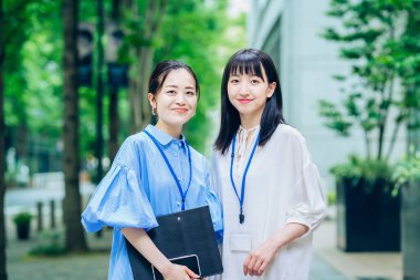 Asian business women lined up outdoors