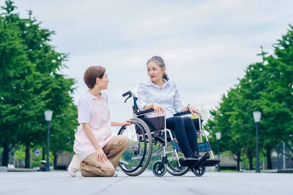 Woman Wheelchair Woman Apron Caring Her — Foto de Stock