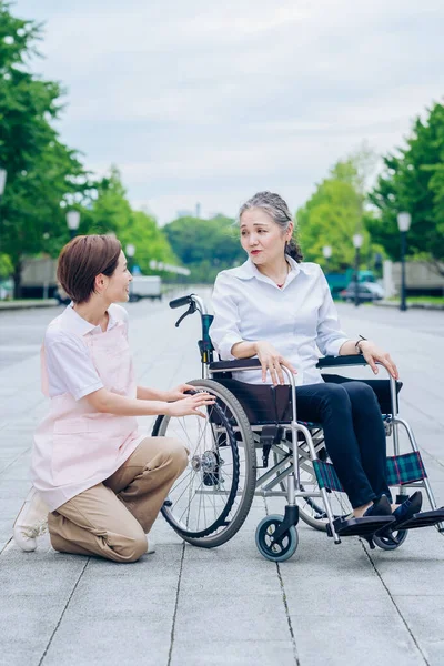 Woman Wheelchair Woman Apron Caring Her — Foto de Stock