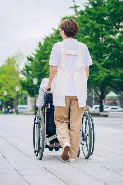 Woman Wheelchair Woman Apron Care Outdoors — Foto de Stock