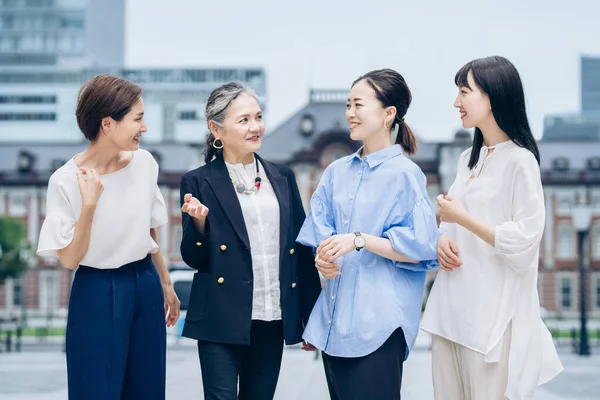 Four Business Women Lined Smiles Outdoors — Stockfoto