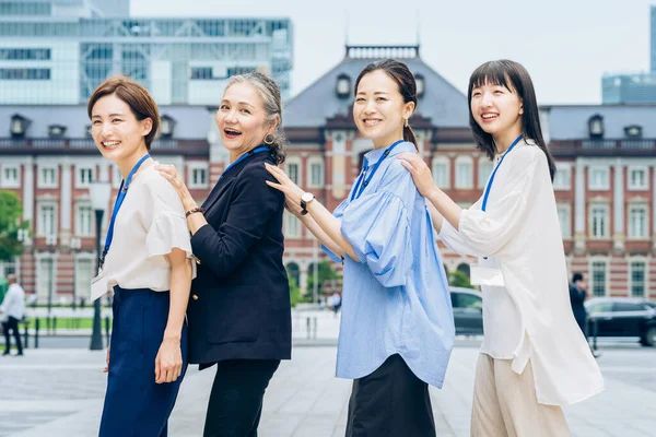 Four Business Women Lined Smiles Outdoors — Stok fotoğraf