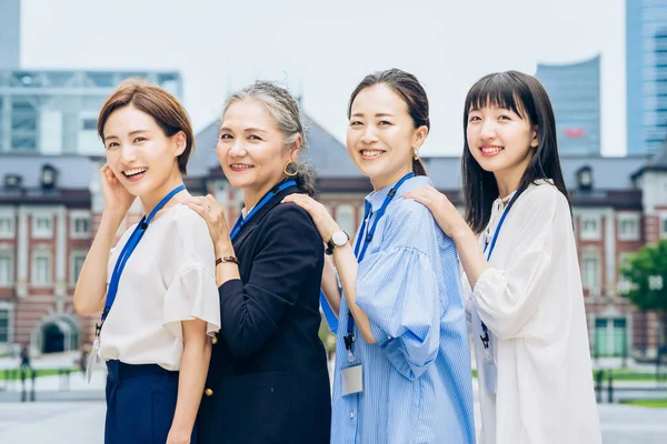 Four Business Women Lined Smiles Outdoors — Stok fotoğraf