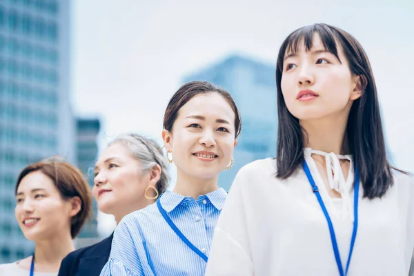 Asian business women lined up outdoors