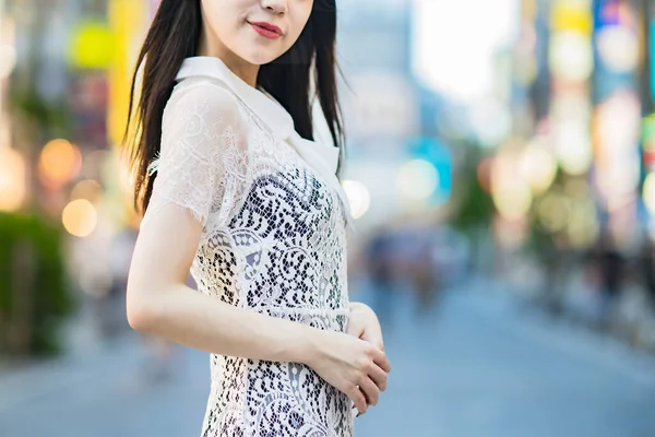 Anonymous woman standing in downtown at evening