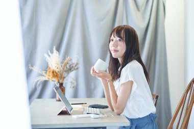 Young woman relaxing and working in her room