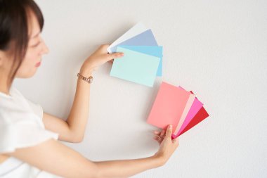 female interior coordinator considering wall color