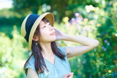 young woman walking in green on fine day