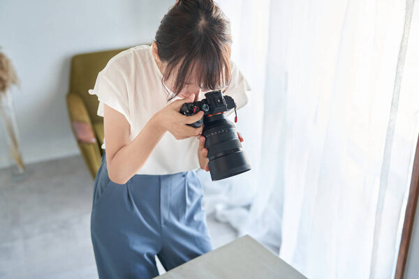 female photographer shooting in the room