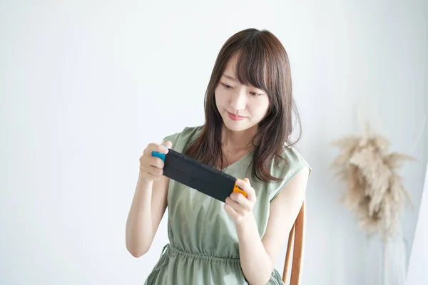 Woman Playing Portable Game Machine Room — Foto Stock