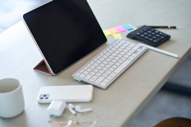 Tablet PC and business items on a casual table