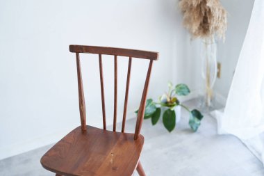 wooden chair by the window in the room