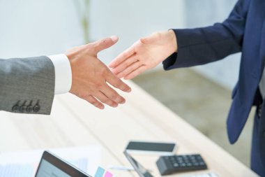 business man and woman shaking hands at office