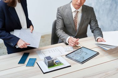 Businessman and businesswoman planning a house design