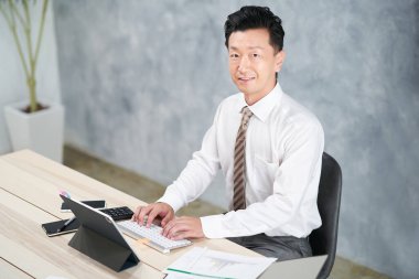 asian businessman doing desk work at office