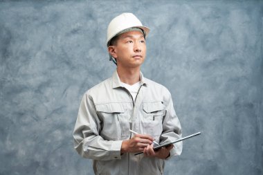 middle man in work clothes and helmet