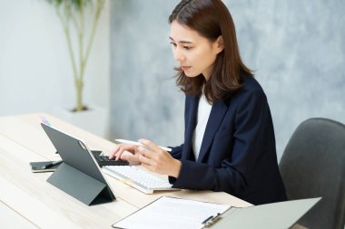 business woman doing desk work at office