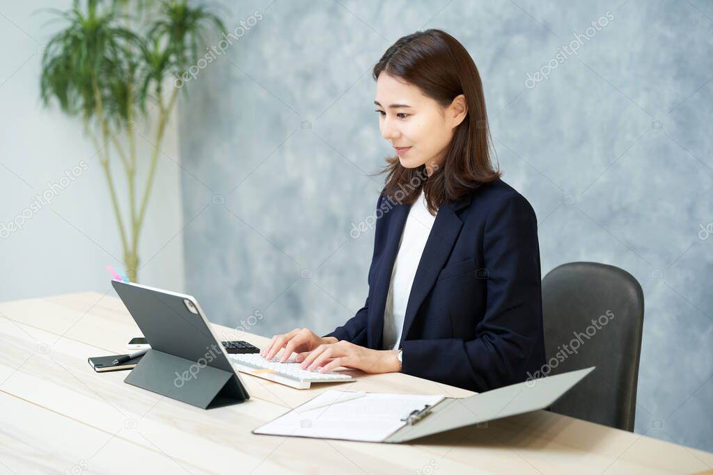 business woman doing desk work at office