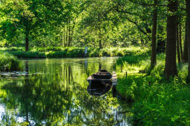 Water canal in the Spreewald Biosphere Reserve in Brandenburg, Germany, with one of the typical wooden boats.
