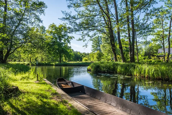 Water channel in the Spreewald Biosphere Reserve in Brandenburg, Germany, with one of the typical wooden boats.