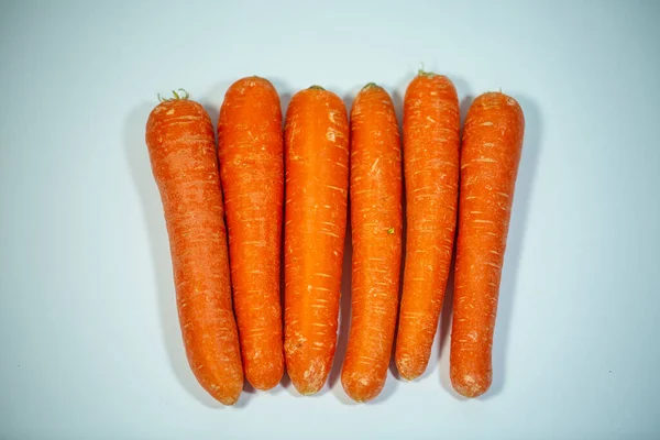 Carrots in a row, funny carrots, white background