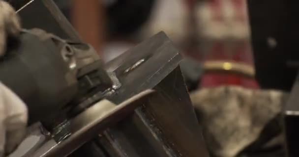 Профессиональные мужские руки в защитных перчатках мастер сварки швов, работающих под углом шлифовальной машины — стоковое видео