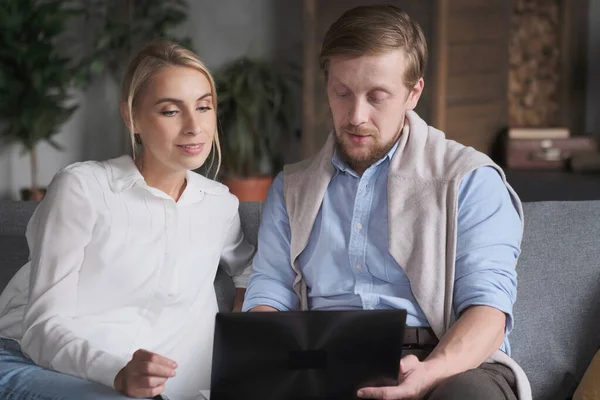 Couple business partner working together discussing deal searching internet use laptop at home Stock Image