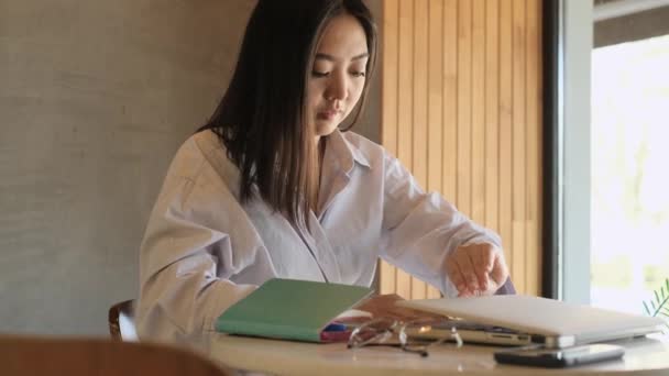 Asian female freelancer working in a cafe — Stock video