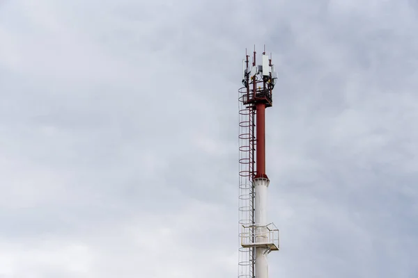 Telecommunication tower of 4G and 5G cellular. Base Station or Base Transceiver Station. Wireless Communication Antenna Transmitter. Telecommunication tower with antennas against blue sky.