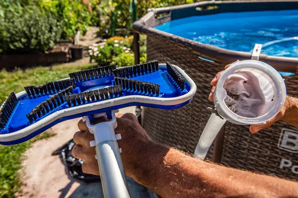 cleaning the pool with a vacuum cleaner. dirty filter after cleaning water. Cleaning equipment for small pools.